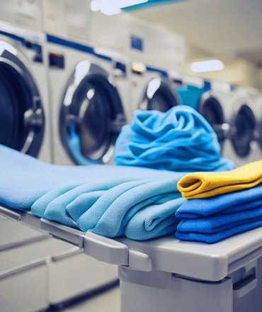 Hotel laundry service with clean, neatly folded clothes on a table.