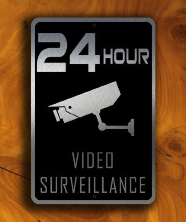 Close-up of a modern CCTV surveillance camera mounted outside a building for 24/7 security monitoring.